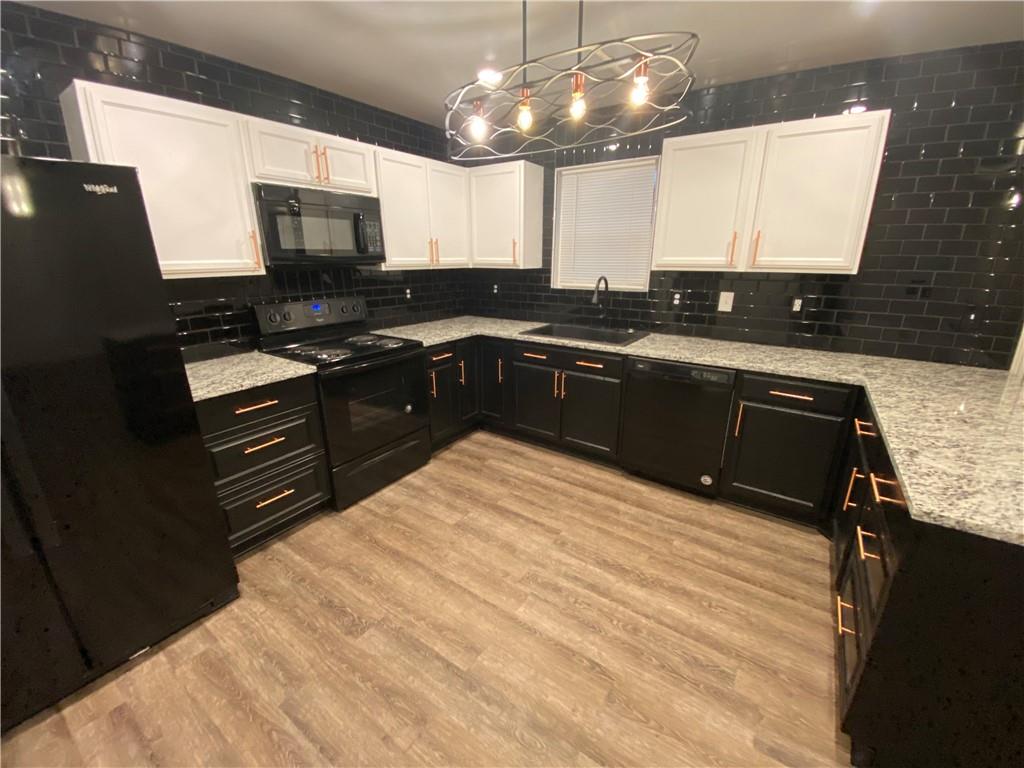 764 Dove Tree Lane Social Circle, GA 30025 - Photo 13 of 48 a kitchen with stainless steel appliances granite countertop a sink stove and microwave