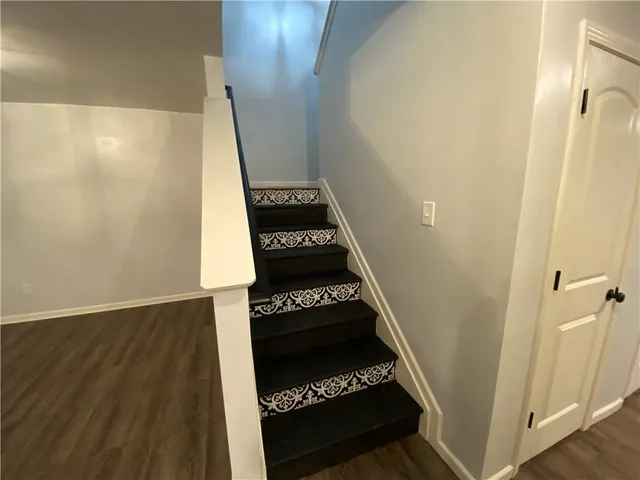 a spacious bathroom with a granite countertop sink toilet and shower
