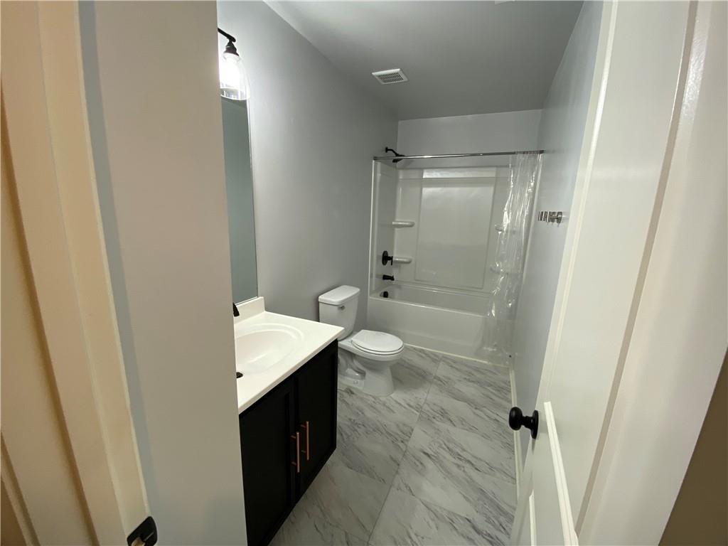 764 Dove Tree Lane Social Circle, GA 30025 - Photo 21 of 48 a spacious bathroom with a granite countertop sink toilet and shower