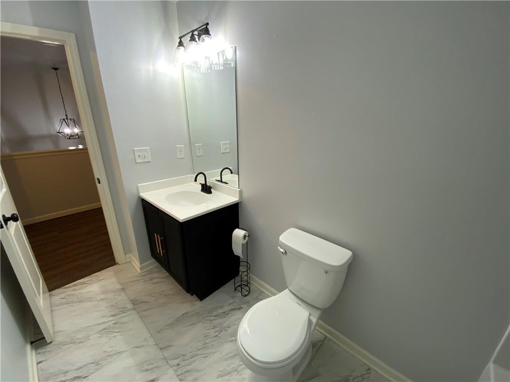 764 Dove Tree Lane Social Circle, GA 30025 - Photo 22 of 48 a bathroom with a toilet sink and mirror