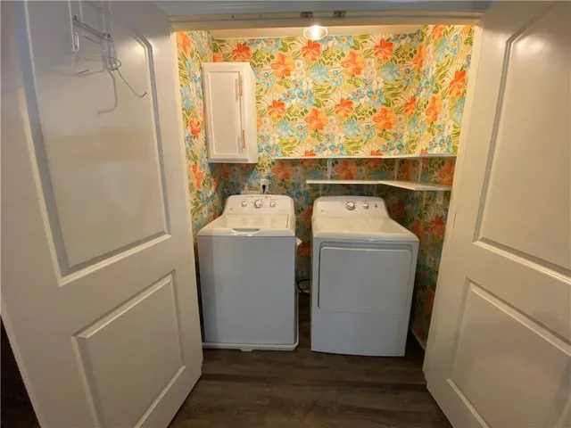 a view of a room with wooden floor and white walls