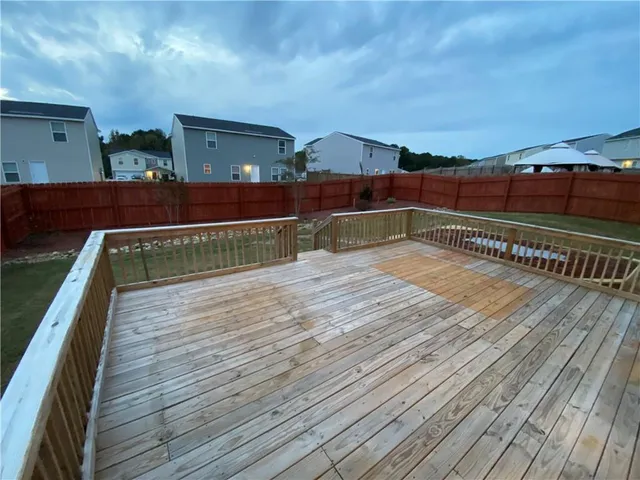 a backyard of a house with yard and trampoline