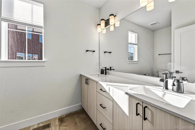 a bathroom with a sink double vanity and a mirror