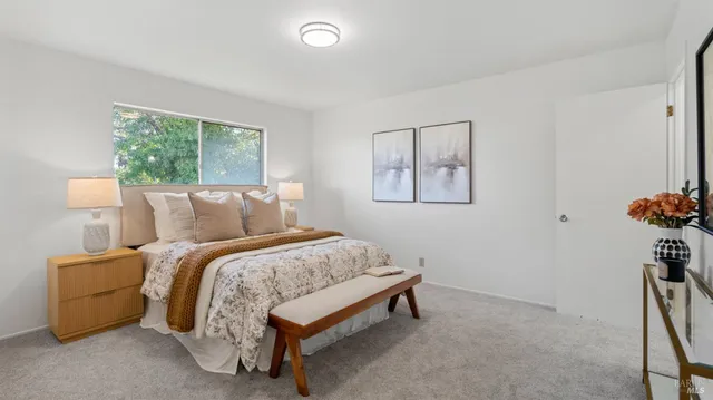 a bed sitting in a bedroom next to a window