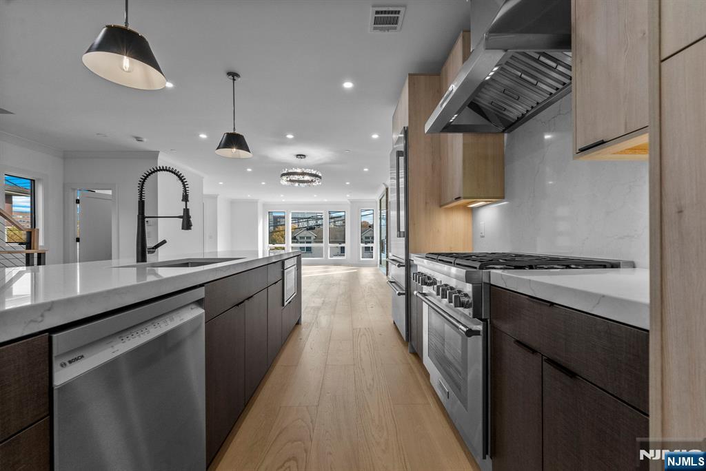 2189 Jones Road Fort Lee, NJ 07024 - Photo 13 of 33 a large kitchen with stainless steel appliances granite countertop a lot of counter space and a sink