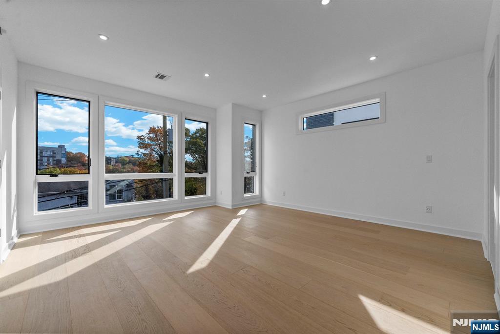 2189 Jones Road Fort Lee, NJ 07024 - Photo 16 of 33 a view of an empty room with a large window and wooden floor