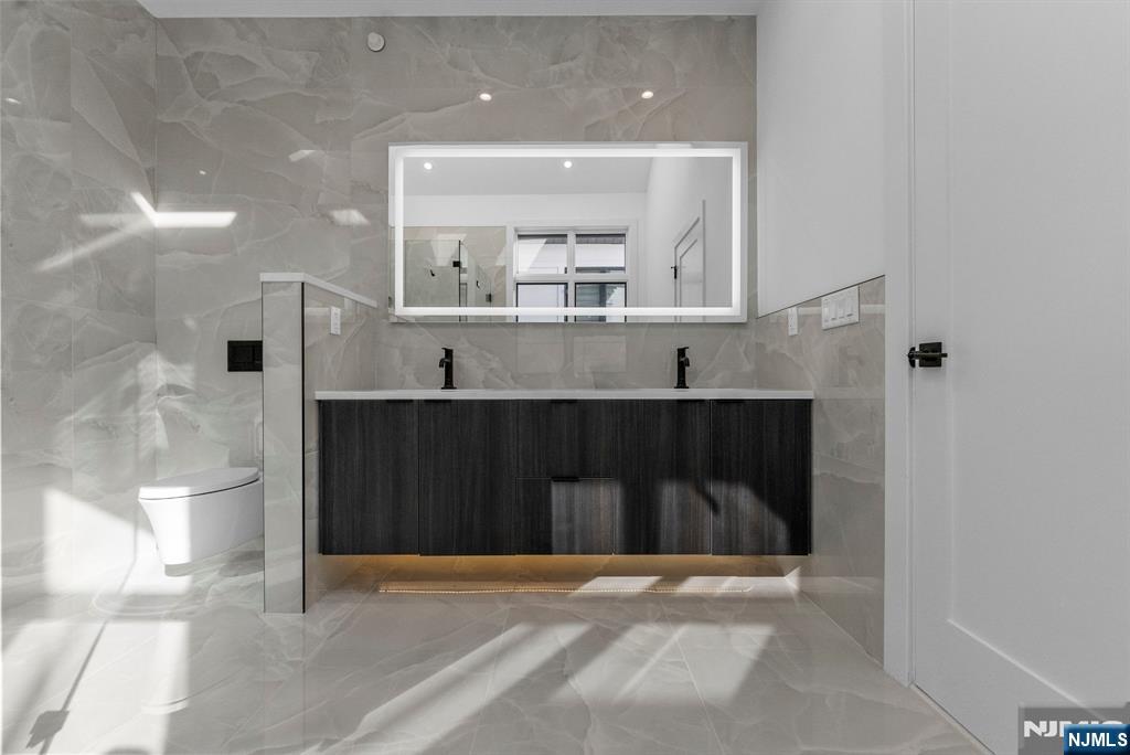 2189 Jones Road Fort Lee, NJ 07024 - Photo 18 of 33 a bathroom with a sink and a mirror