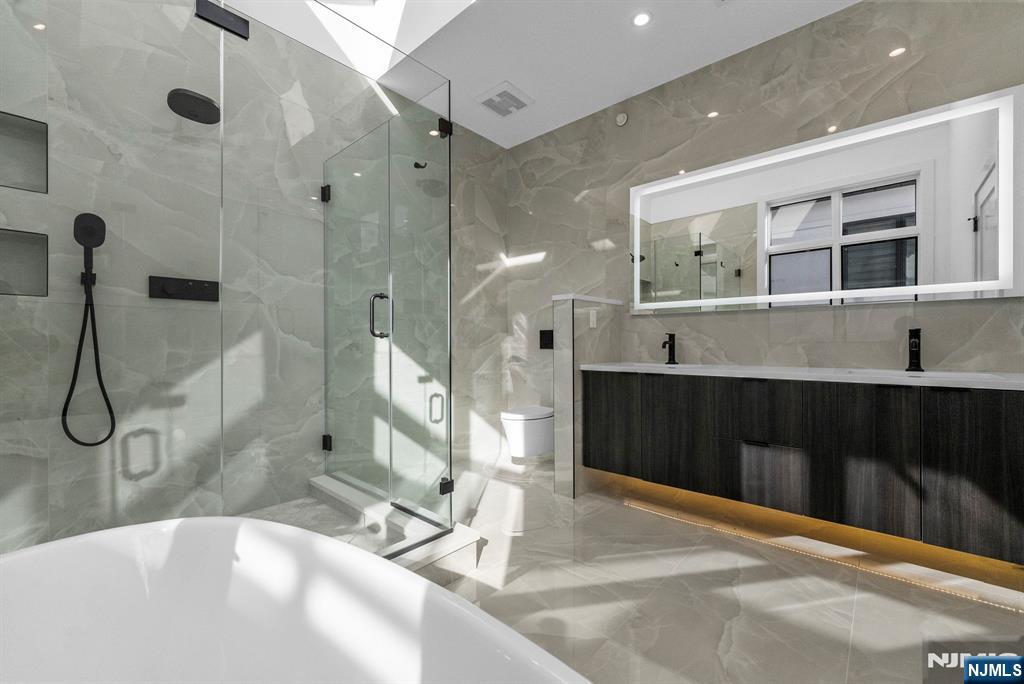 2189 Jones Road Fort Lee, NJ 07024 - Photo 19 of 33 a bathroom with a double vanity sink a large mirror and shower