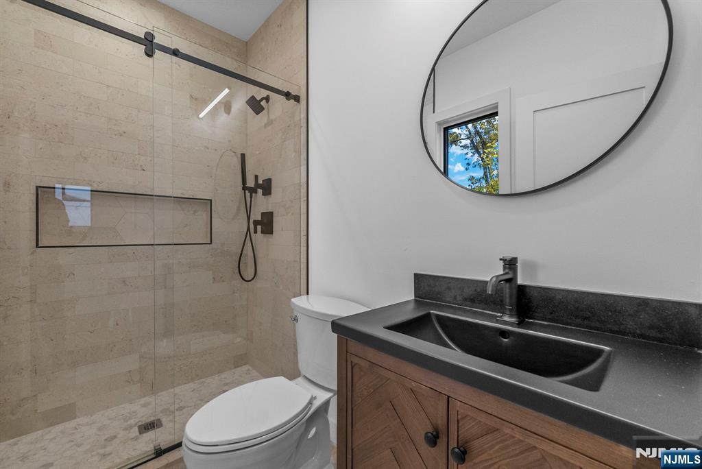 2189 Jones Road Fort Lee, NJ 07024 - Photo 22 of 33 a bathroom with a sink a toilet and a mirror