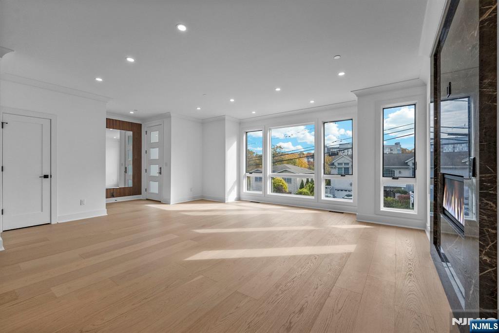 2189 Jones Road Fort Lee, NJ 07024 - Photo 4 of 33 a view of an empty room with wooden floor and a window
