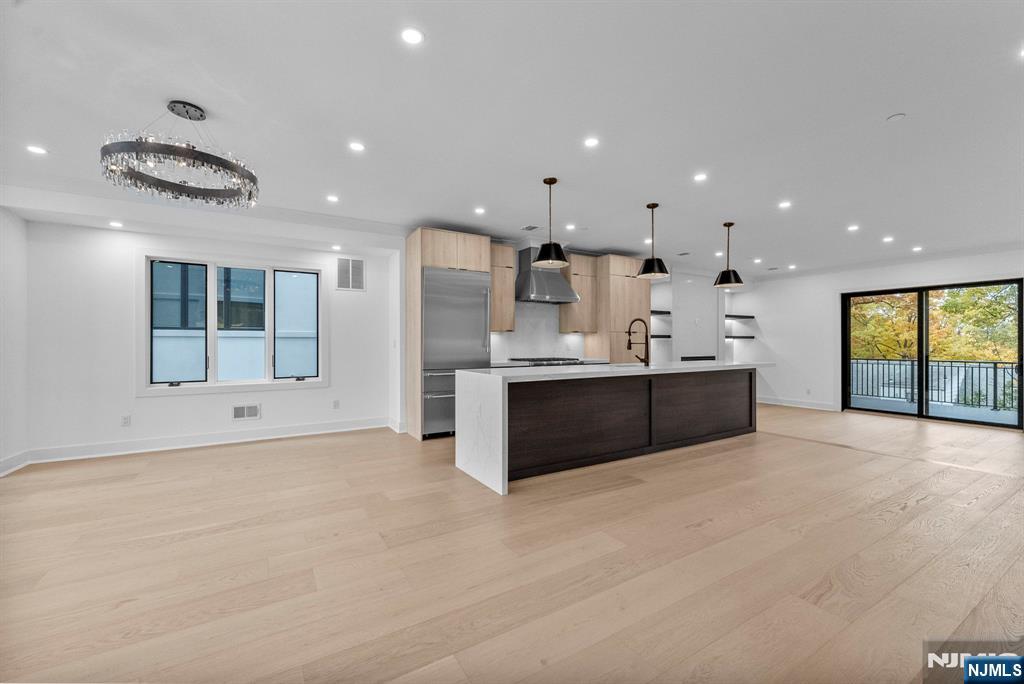 2189 Jones Road Fort Lee, NJ 07024 - Photo 7 of 33 a large kitchen with stainless steel appliances kitchen island a large counter top and a floors