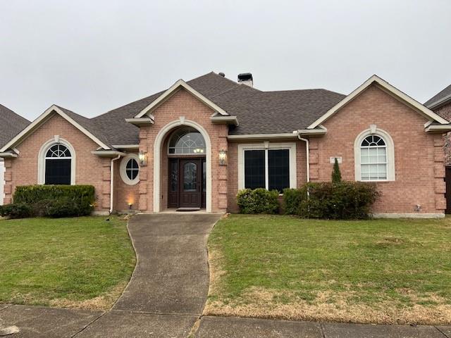 a view of a yard in front of a brick house