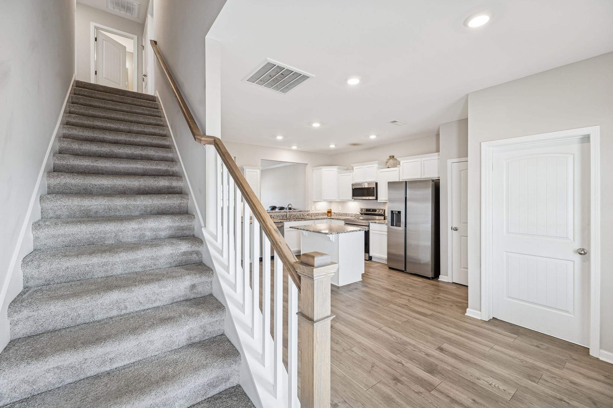 501 Ruby Cate Way Murfreesboro, TN 37128 - Photo 14 of 27 a view of a kitchen with wooden floor and stairs