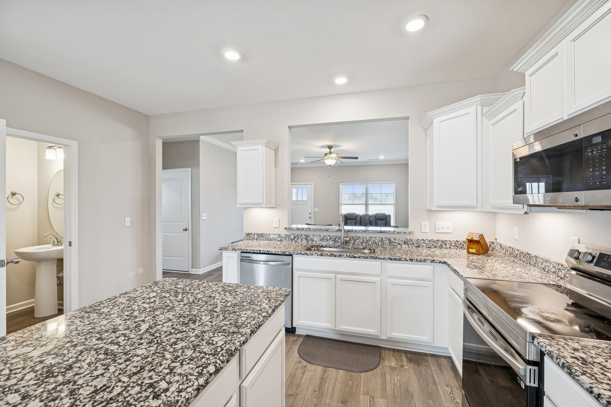 501 Ruby Cate Way Murfreesboro, TN 37128 - Photo 7 of 27 a kitchen with a stove a sink and a refrigerator