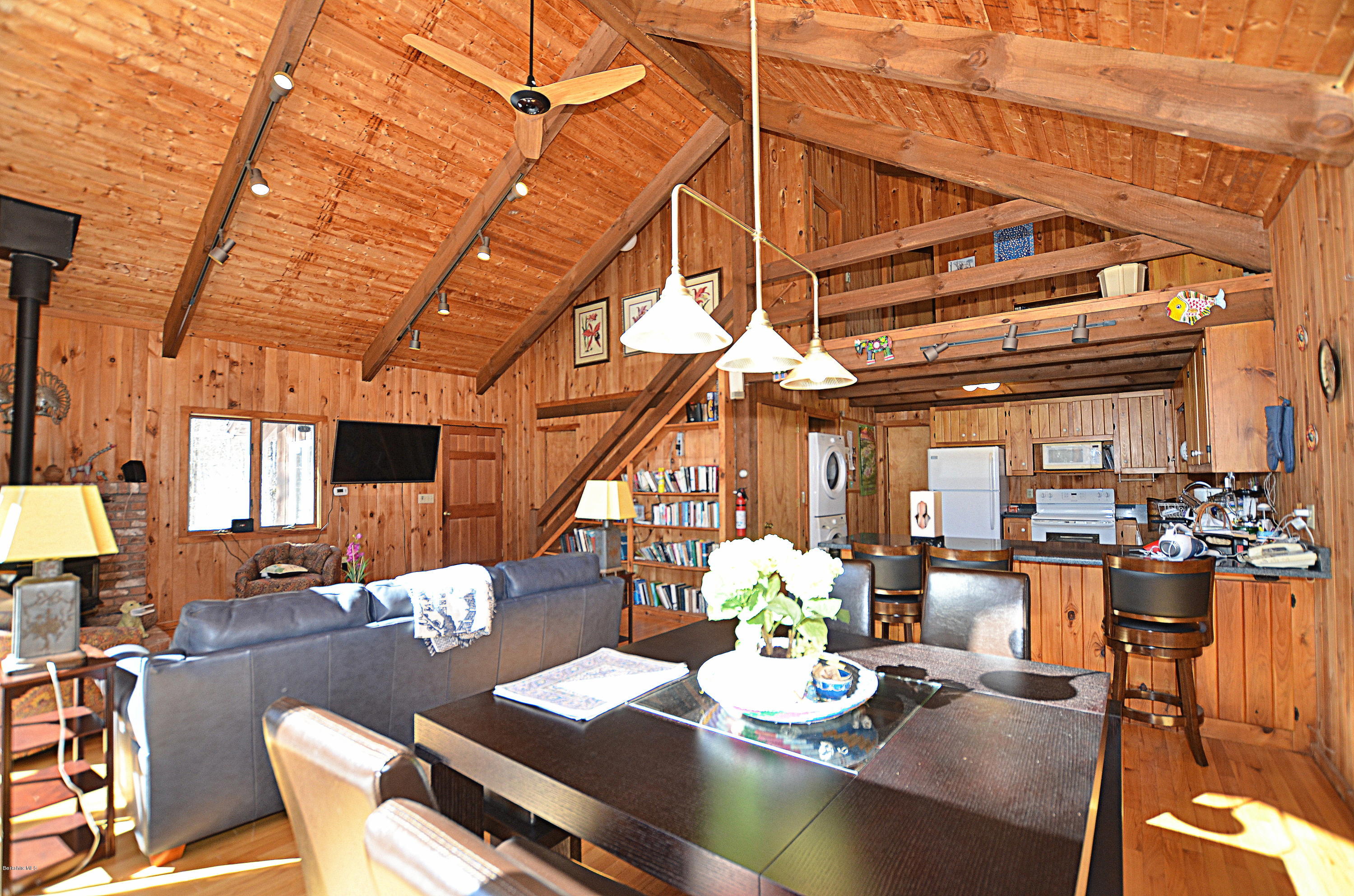 164 Moberg Road Becket, MA 01223 - Photo 5 of 25 a dining room with furniture a chandelier and wooden floor