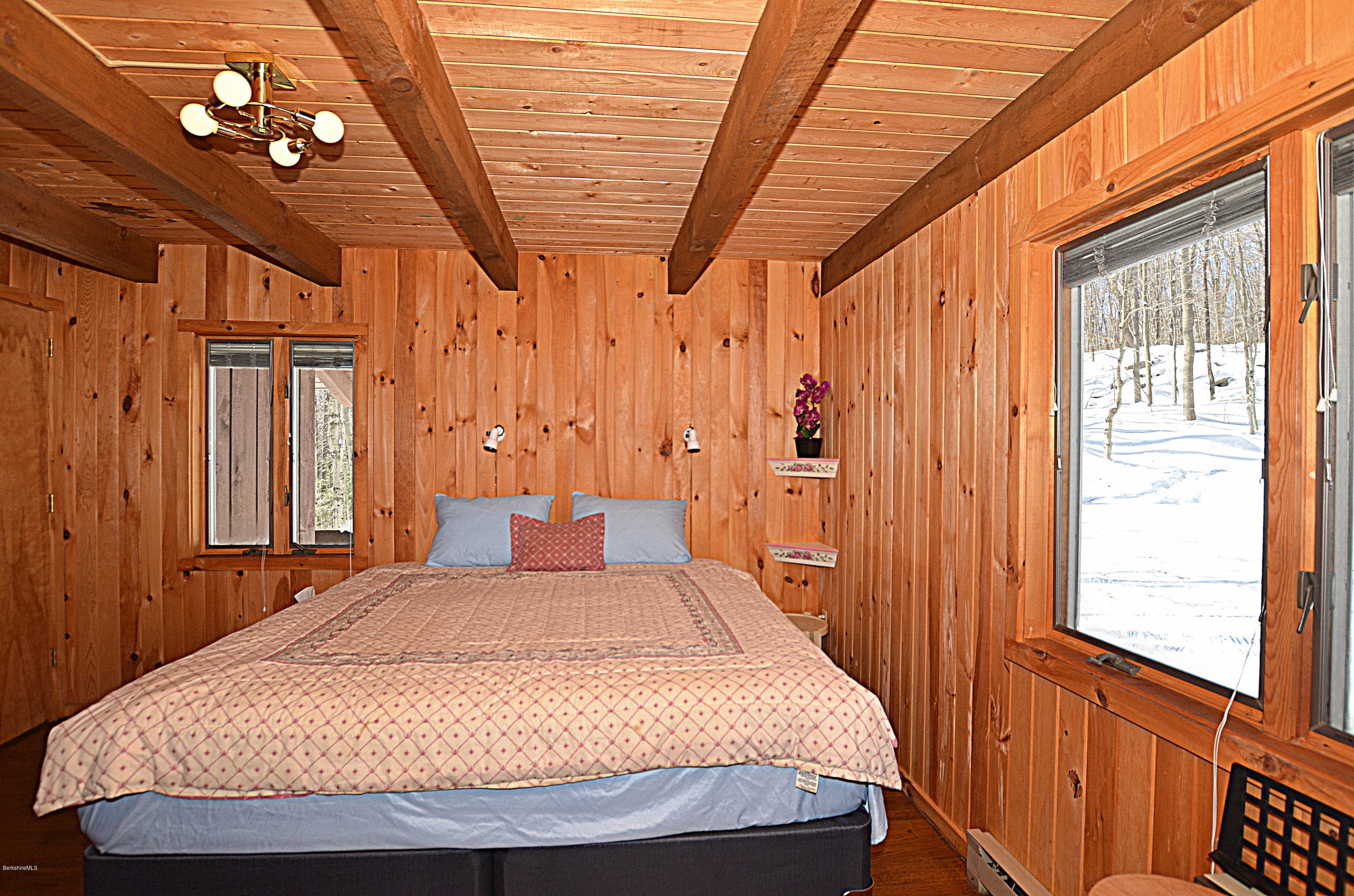 164 Moberg Road Becket, MA 01223 - Photo 8 of 25 a bedroom with a bed next to a window