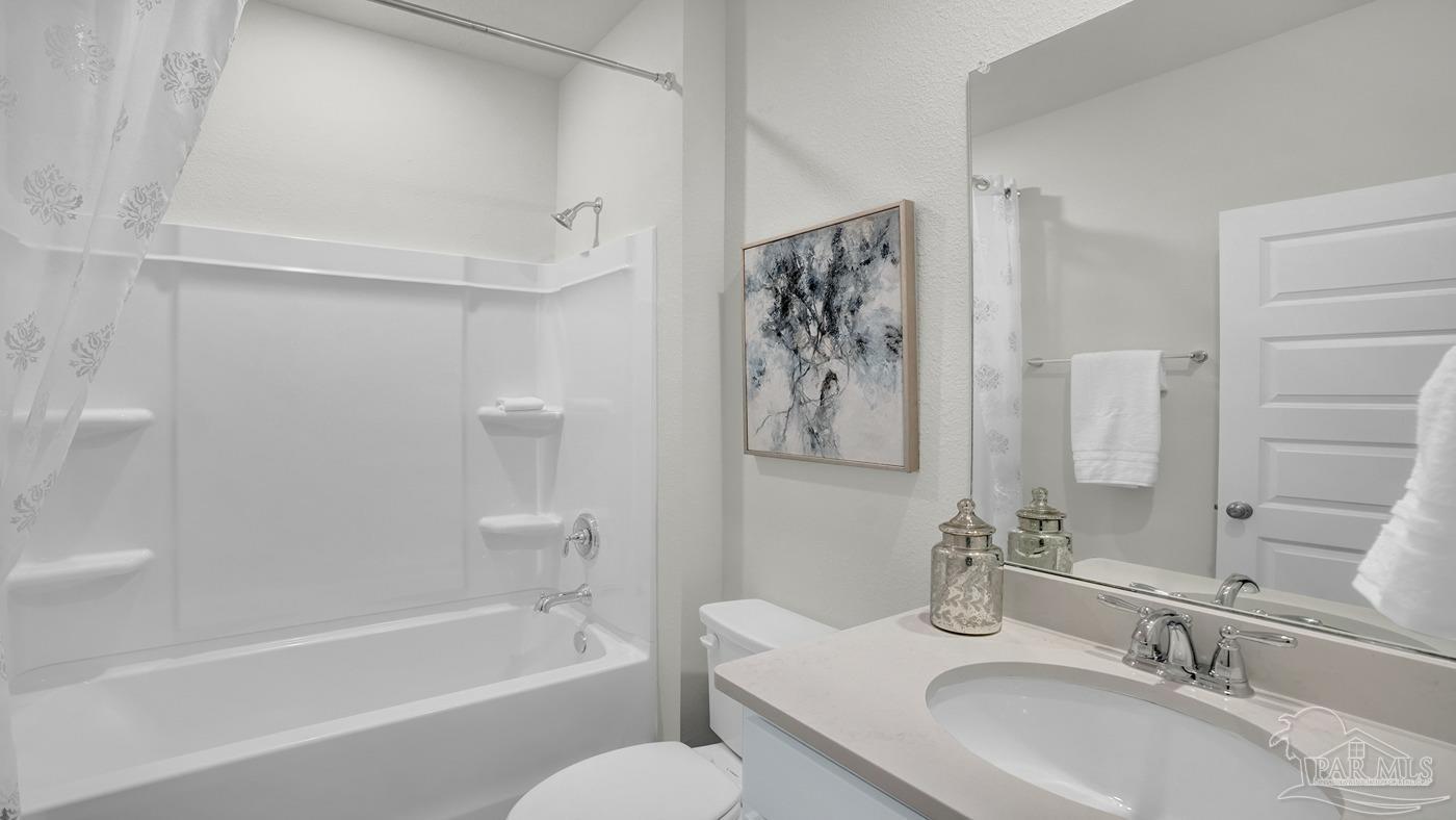 2172 Sandhill Street Cantonment, FL 32533 - Photo 13 of 30 a bathroom with a granite countertop sink a toilet and a bathtub
