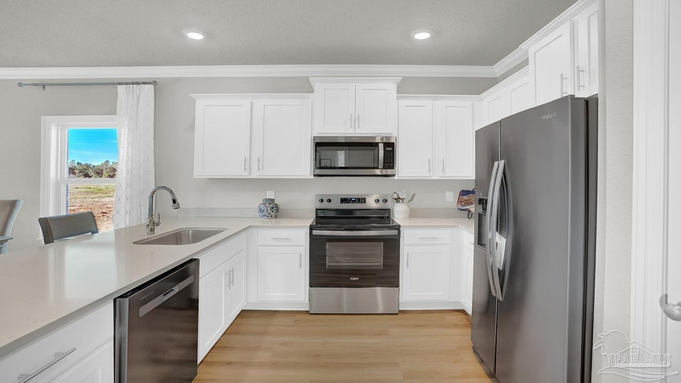 2172 Sandhill Street Cantonment, FL 32533 - Photo 18 of 30 a kitchen with a refrigerator stove and sink