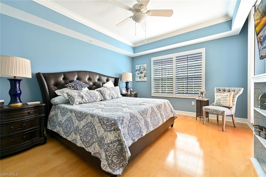 401 Bayfront Place, Unit 3301 Naples, FL 34102 - Photo 12 of 24 a bed sitting in a bedroom next to a window with a chandelier