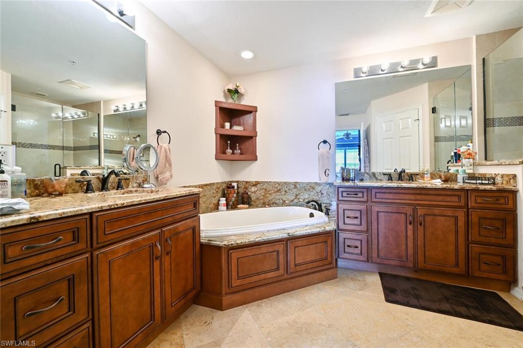 401 Bayfront Place, Unit 3301 Naples, FL 34102 - Photo 14 of 24 a spacious bathroom with a double vanity sink a mirror and a bathtub