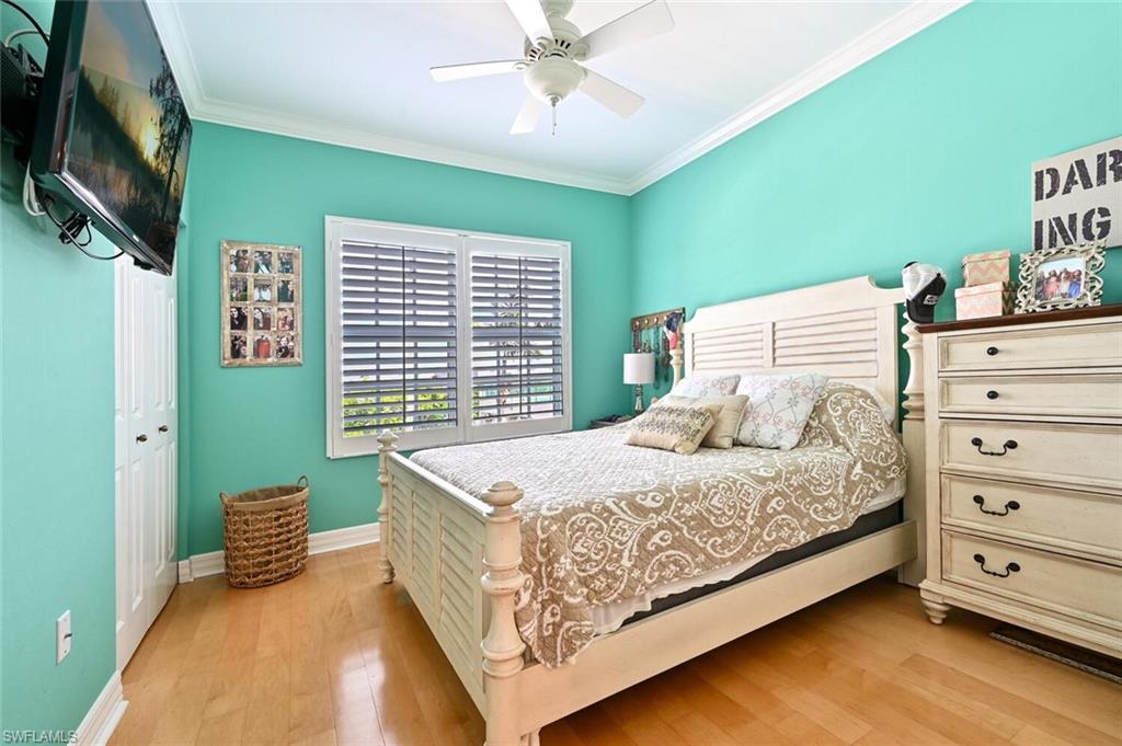 401 Bayfront Place, Unit 3301 Naples, FL 34102 - Photo 15 of 24 a bedroom with a bed and a flat tv screen