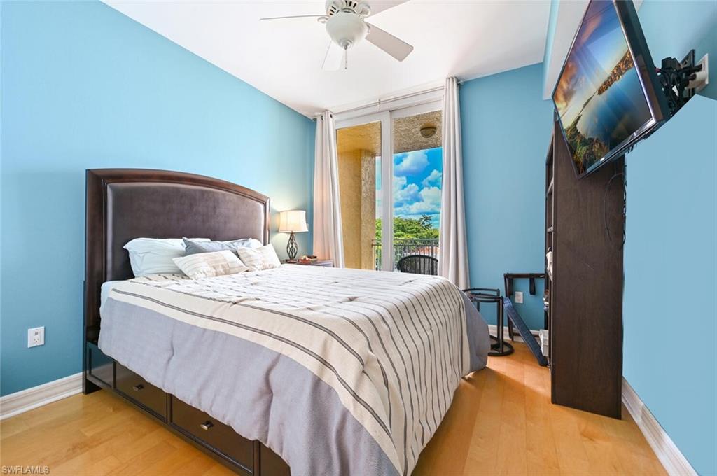 401 Bayfront Place, Unit 3301 Naples, FL 34102 - Photo 16 of 24 a bedroom with a bed and a chandelier