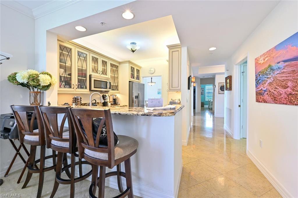 401 Bayfront Place, Unit 3301 Naples, FL 34102 - Photo 8 of 24 a dining room filled chandelier and wooden floor