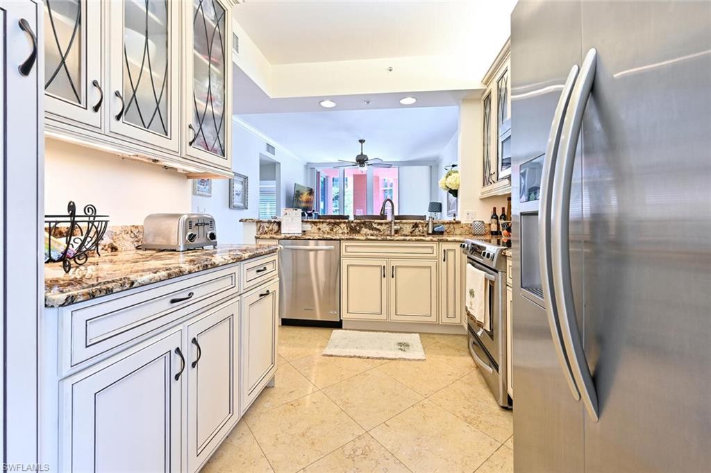 401 Bayfront Place, Unit 3301 Naples, FL 34102 - Photo 9 of 24 a kitchen with stainless steel appliances granite countertop a sink a stove and a refrigerator