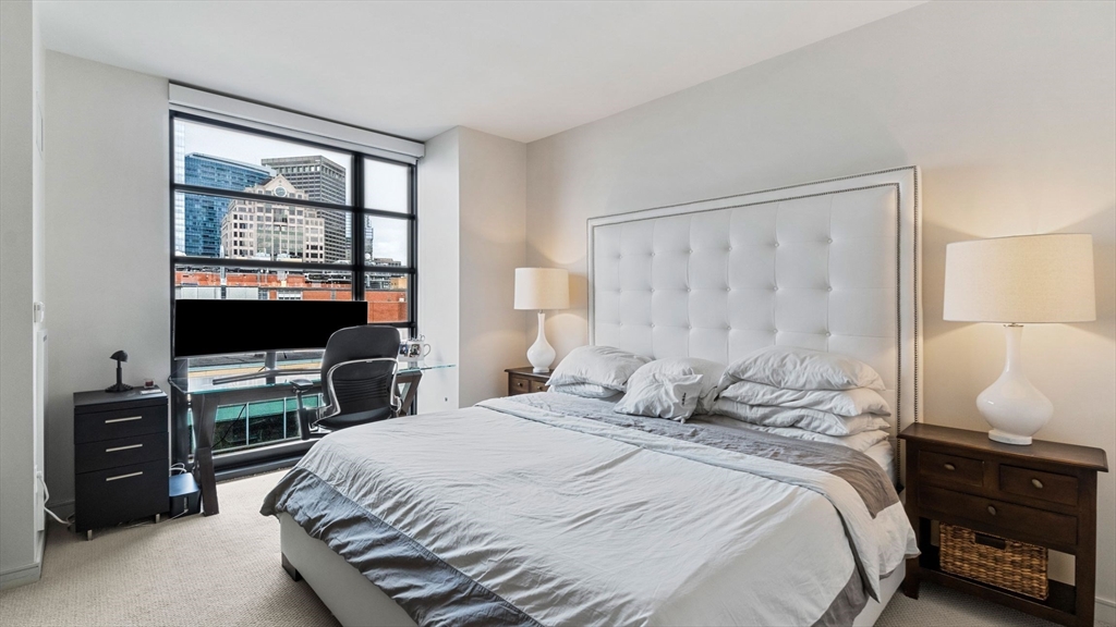 580 Washington Street, Unit 1105 Boston, MA 02111 - Photo 9 of 28 a bedroom with a bed and a window