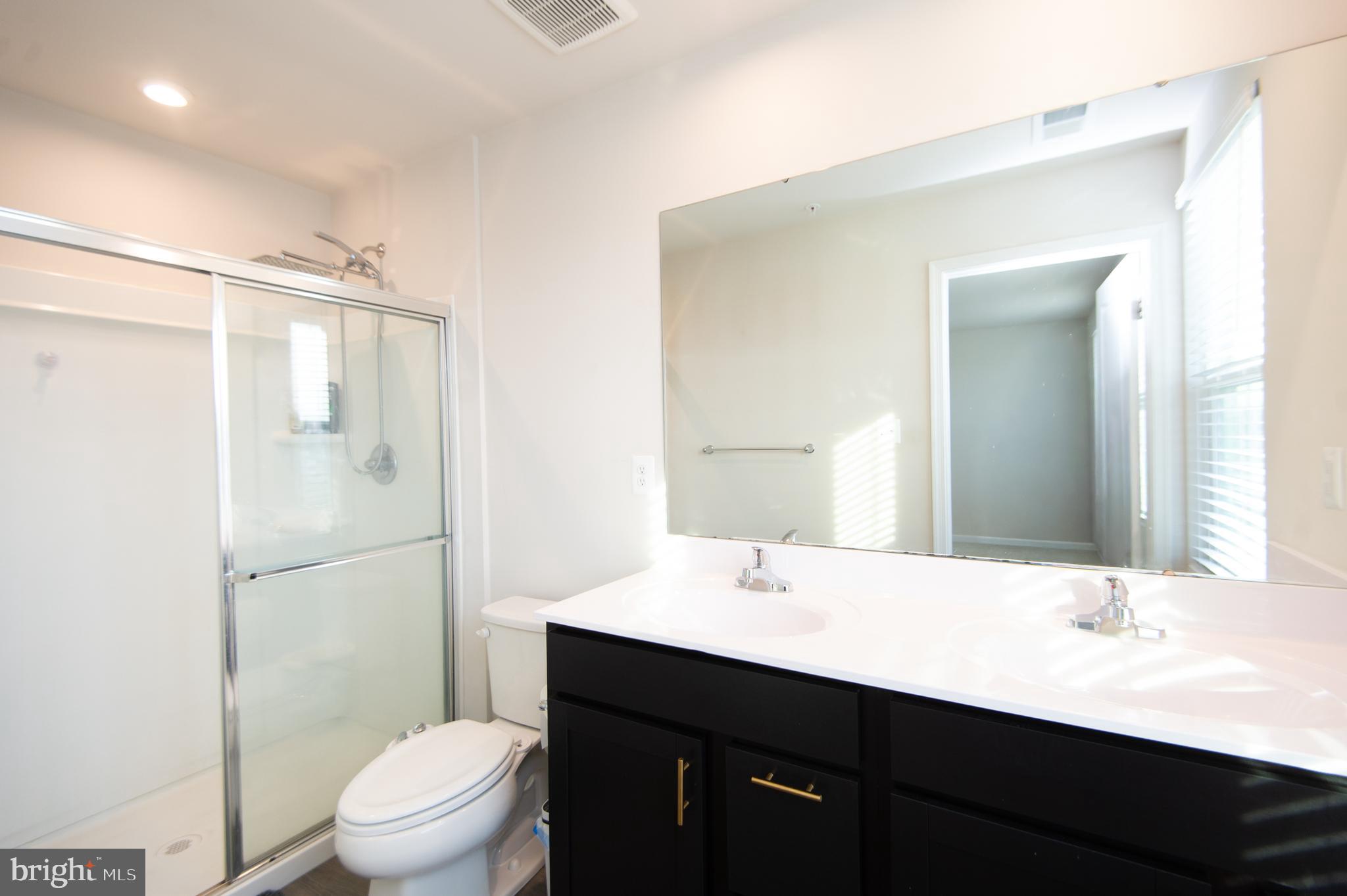 120 Mariners Way Cambridge, MD 21613 - Photo 13 of 44 a bathroom with a double vanity sink toilet and shower