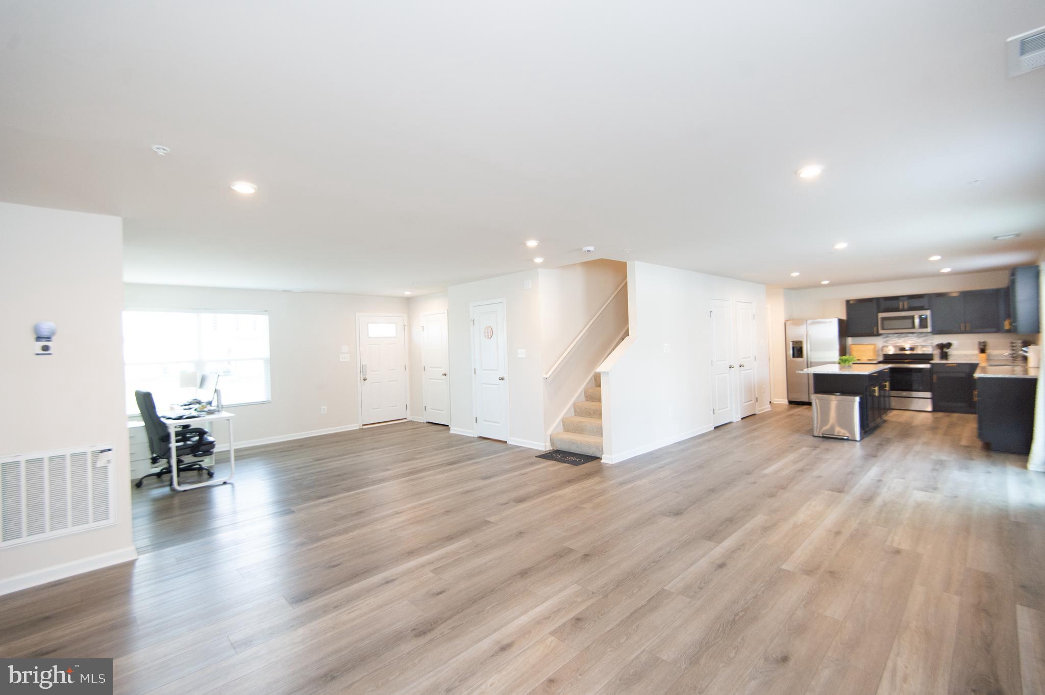 120 Mariners Way Cambridge, MD 21613 - Photo 7 of 44 an empty room with wooden floor and windows