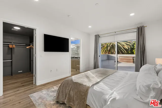 a bedroom with a bed and a night stand