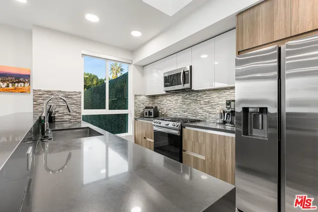 a bathroom with a granite countertop sink mirror toilet and bathtub