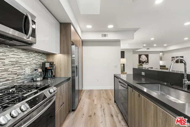 a stove top oven sitting inside of a kitchen
