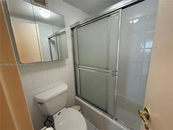 a bathroom with a shower and a toilet