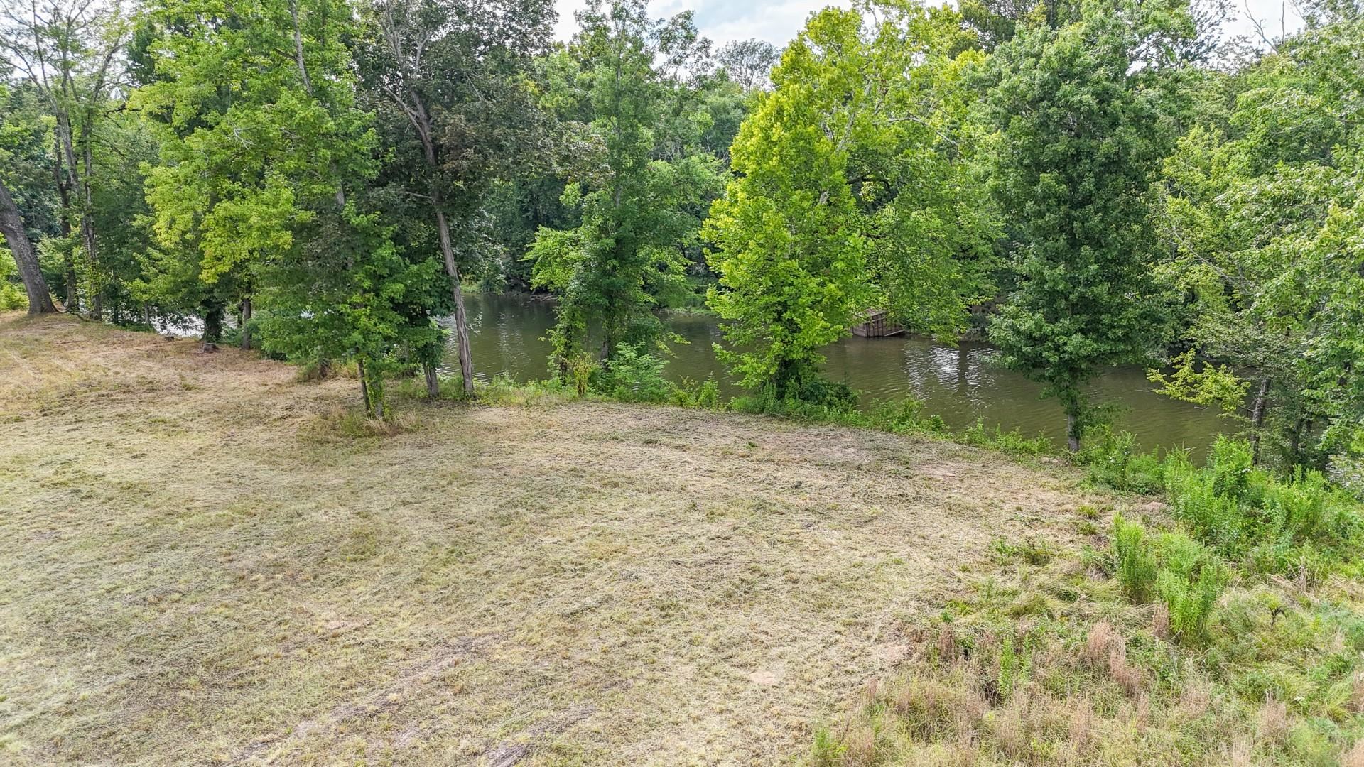 124 Launch Ramp Cove Savannah, TN 38372 - Photo 22 of 33 a backyard of a house with lots of green space and lake view