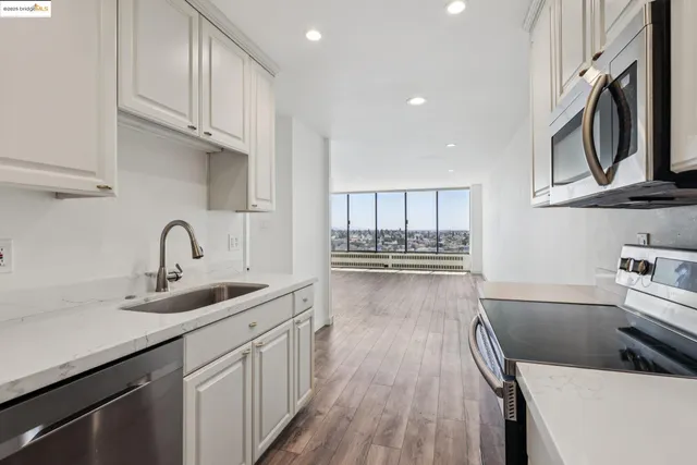 a kitchen with cabinets a sink and appliances