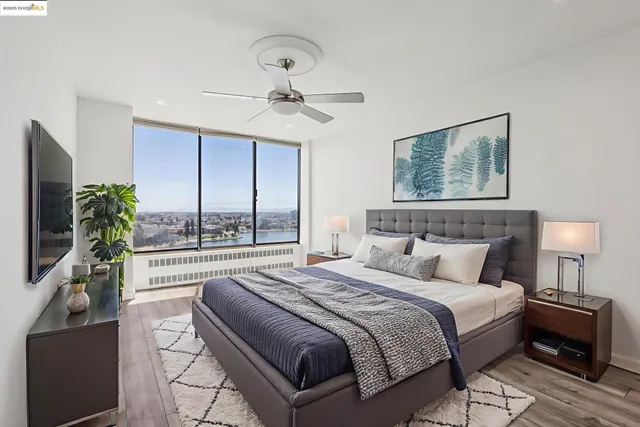 a bedroom with a large bed and a chandelier