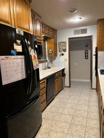 a open kitchen with stainless steel appliances granite countertop a sink stove and cabinets