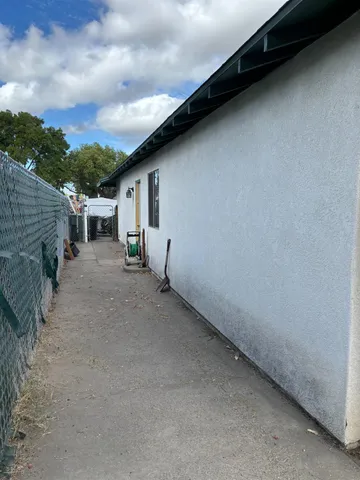 a backyard of a house with table and chairs