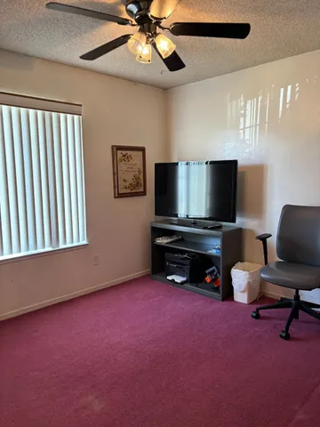 a livingroom with window and a flat screen tv
