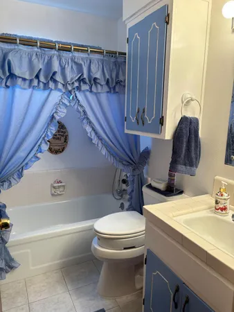 a bathroom with a sink a toilet and bathtub