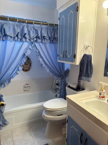 a bathroom with a sink a toilet and bathtub