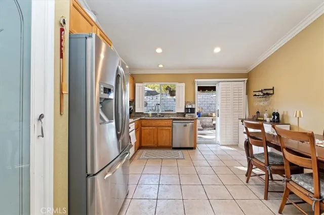 a large kitchen with a large window and stainless steel appliances