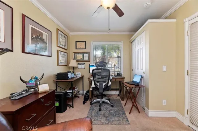 a view of a livingroom with workspace and a window