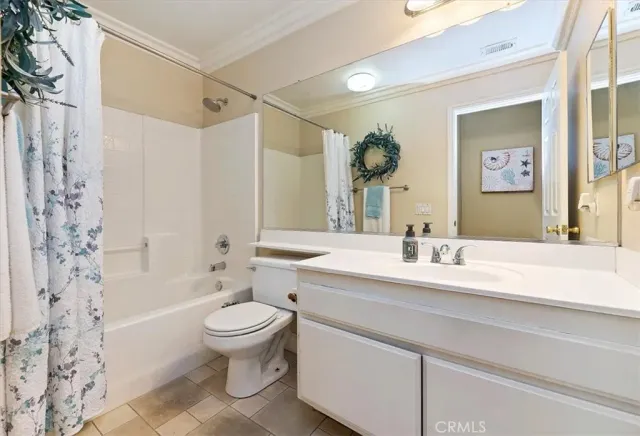 a bathroom with a sink a toilet and a large mirror