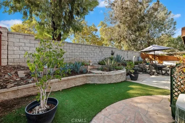 a garden with plants and a fountain