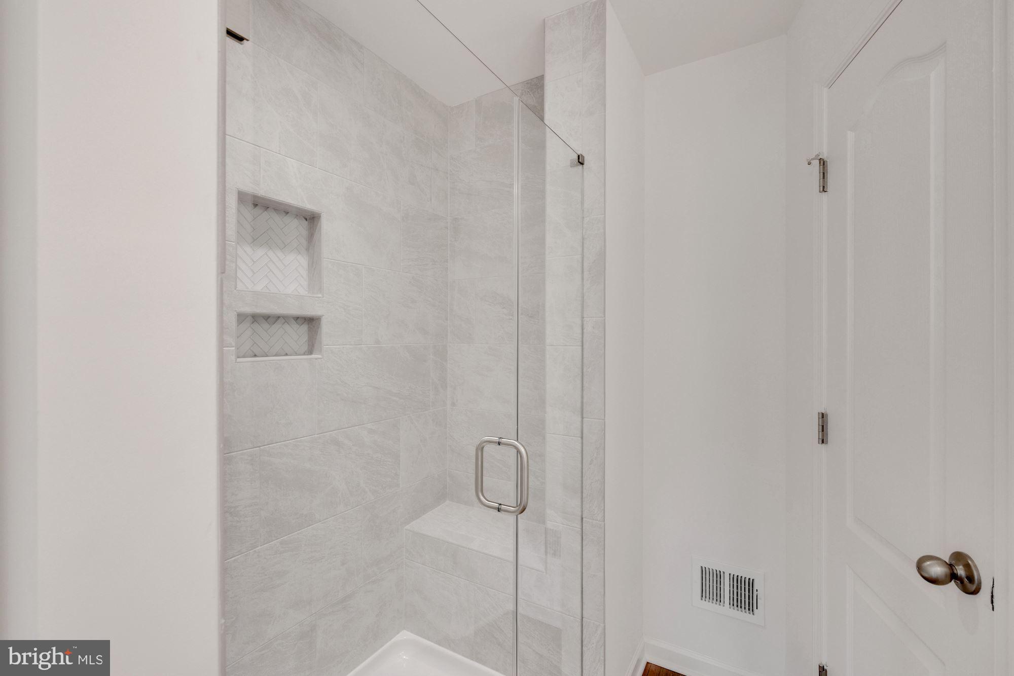 116 Copeley Circle Winchester, VA 22602 - Photo 15 of 23 a bathroom with a glass shower door