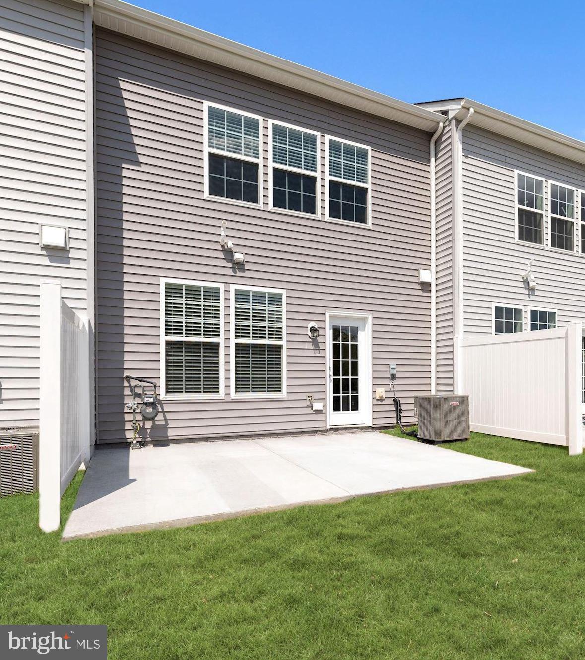 116 Copeley Circle Winchester, VA 22602 - Photo 22 of 23 a front view of a house with a yard and garage