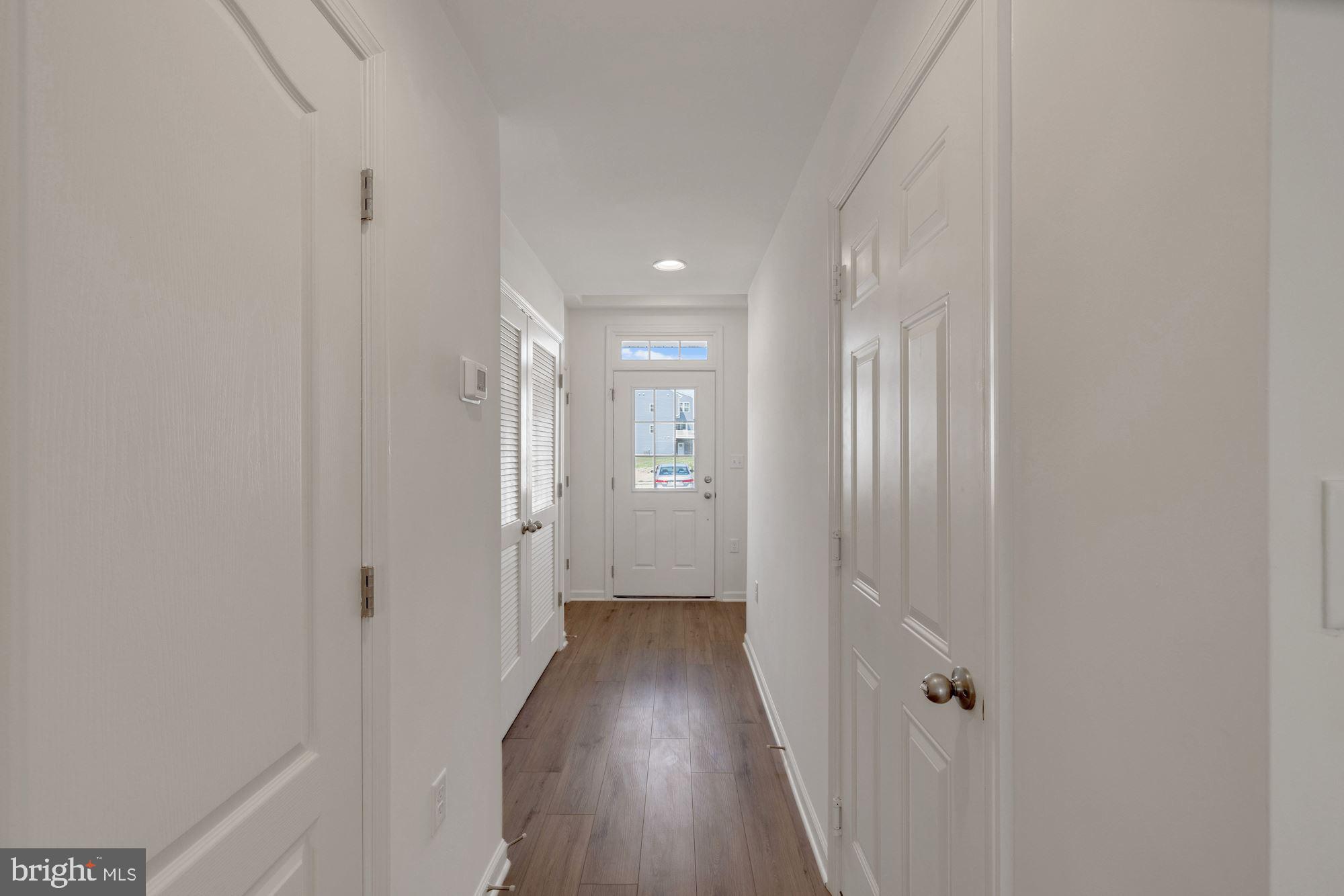 116 Copeley Circle Winchester, VA 22602 - Photo 3 of 23 a view of a hallway with wooden floor and a bathroom